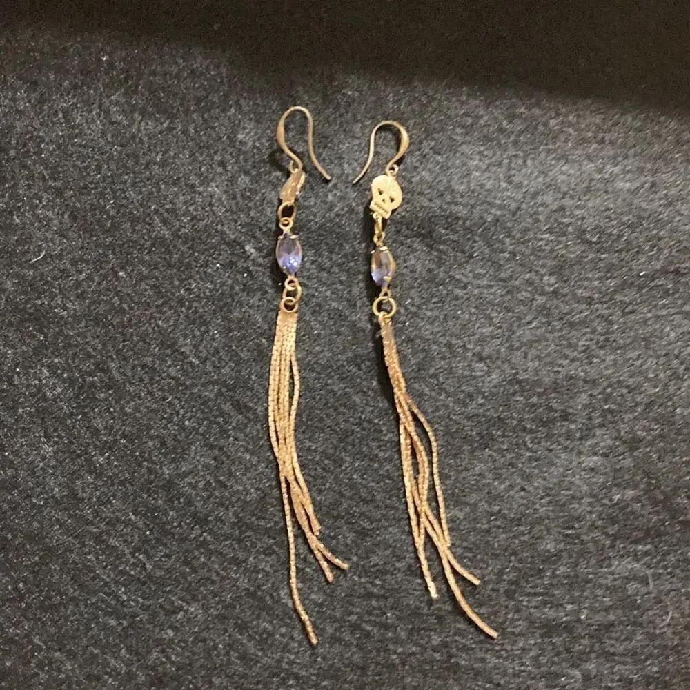 Earrings skulls and purple stones dangling golden braids